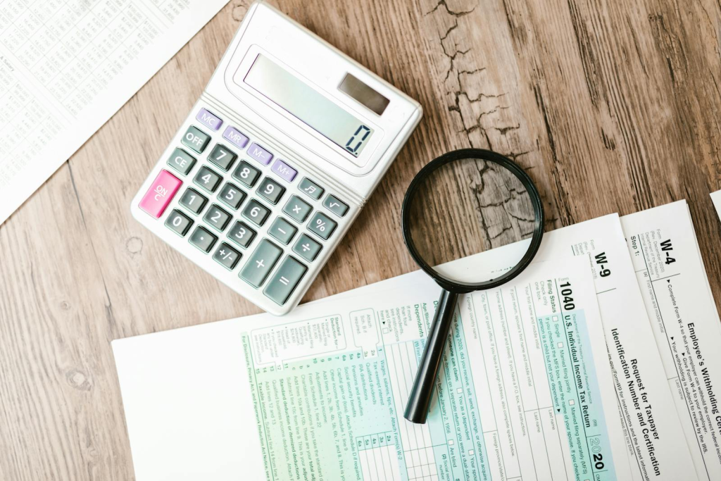 Property tax forms with calculator and magnifying glass - Atlanta tax appeal guide 2026